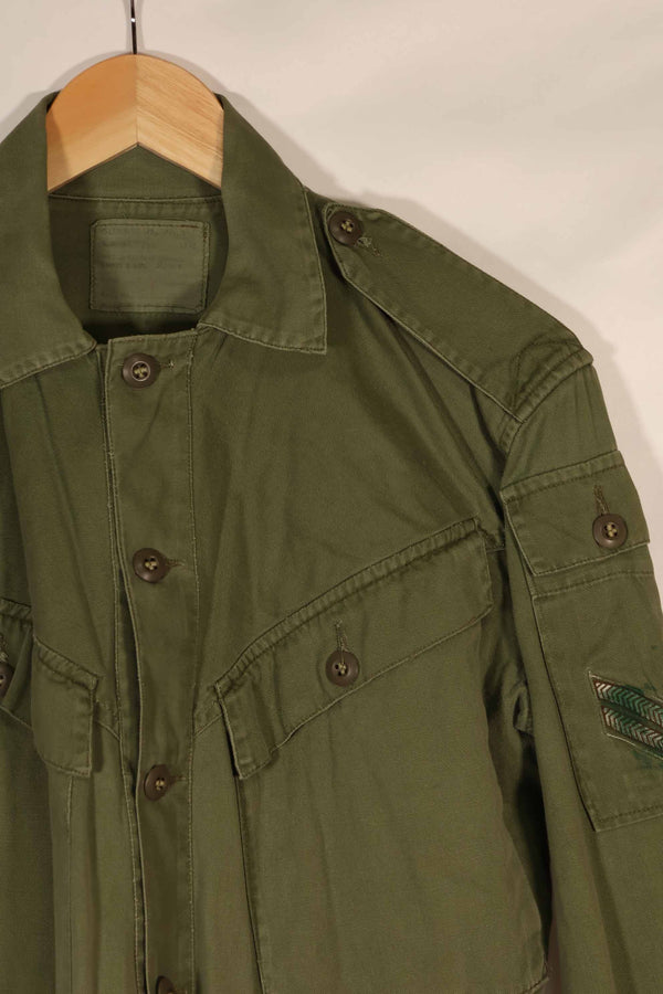 Real 1970 Australian Army OD Fatigue shirt with rank insignia, size unreadable.