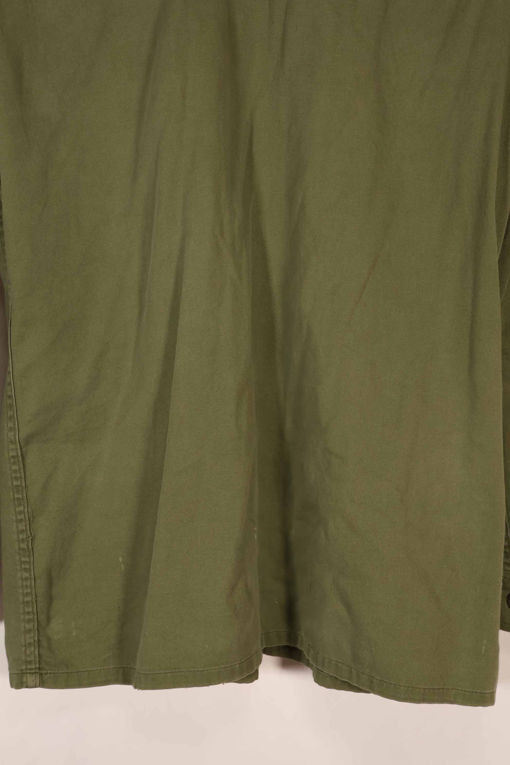 Real 1970 Australian Army OD Fatigue shirt with rank insignia, size unreadable.