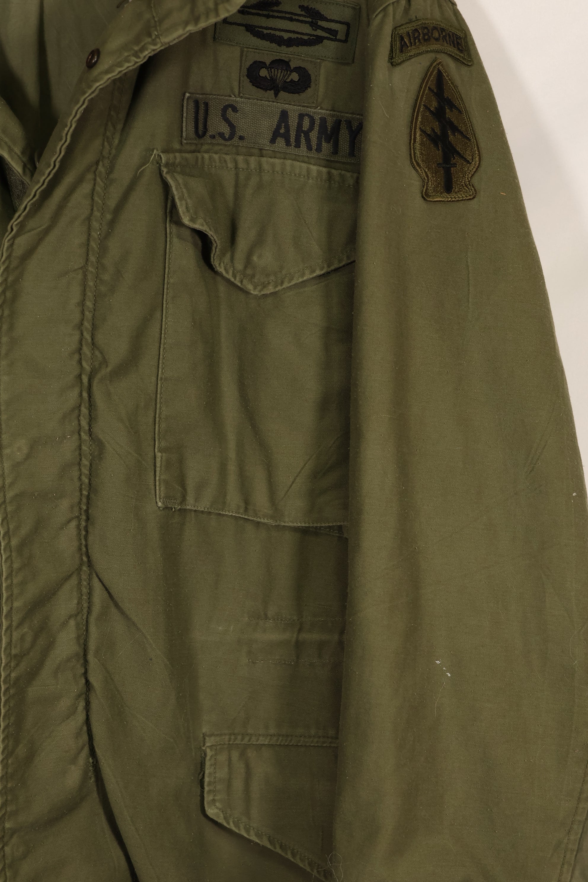 Real owned by former SF member, first model M65 field jacket, estimated 1965-1966, used.