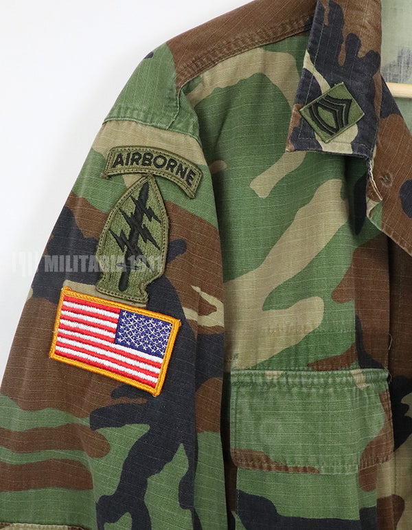 US SURPLUS U.S. Army Special Forces Woodland Camouflage Jacket, 1996, with patches.